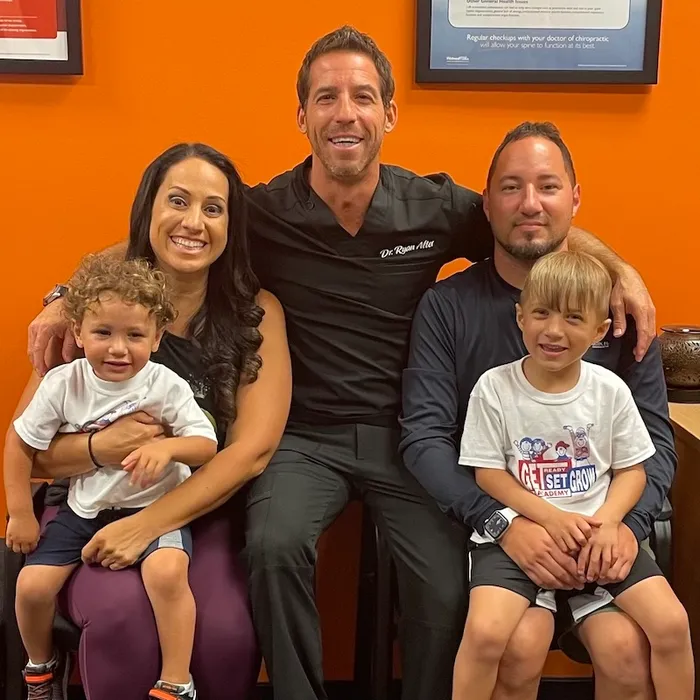 Dr. Ryan Alter with a happy family of patients