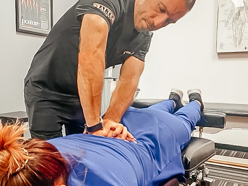 Dr. Ryan Alter adjusting a patient's lower back at Alter Chiropractic