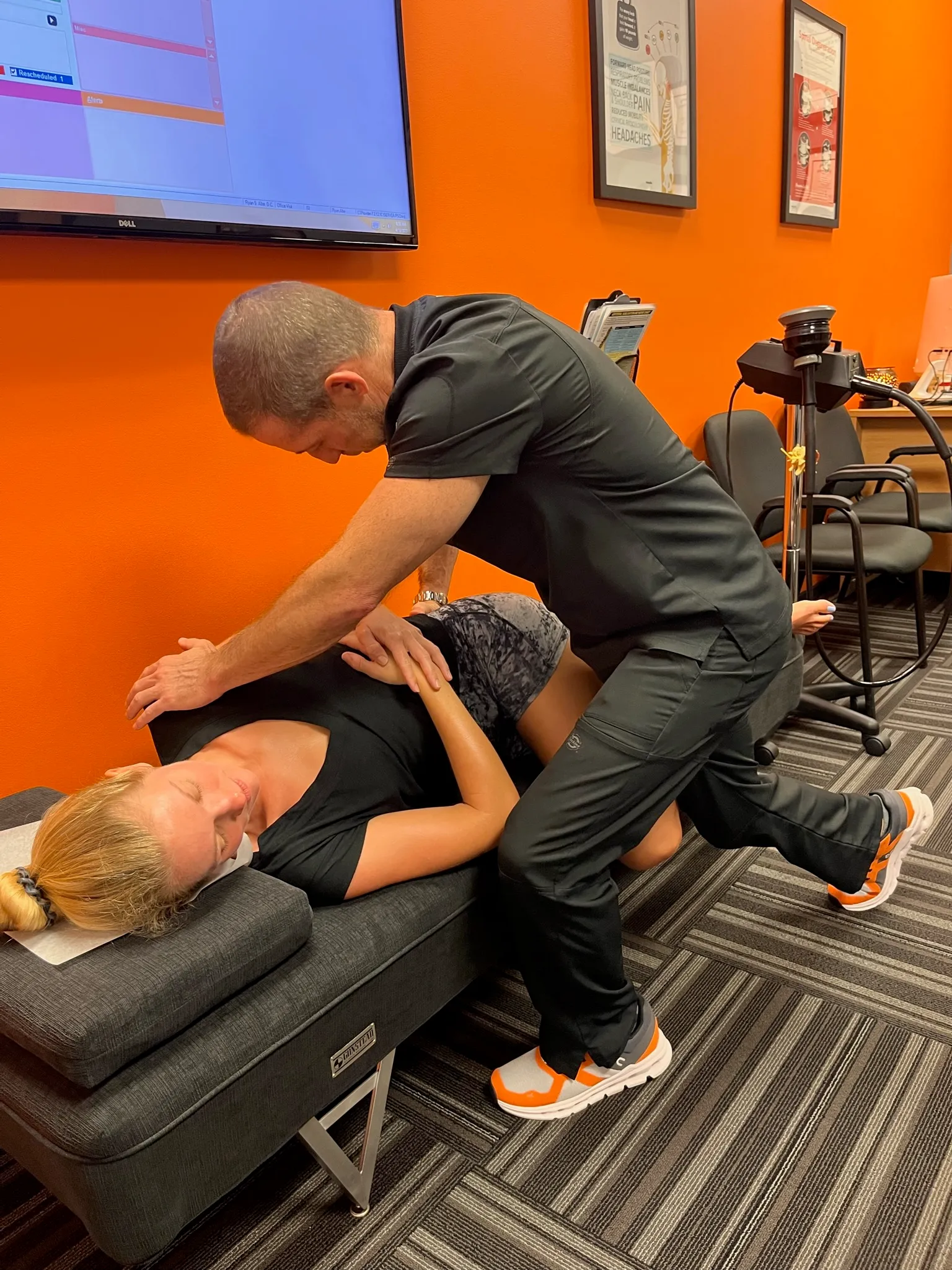Dr. Ryan Alter performing a side-posture spinal adjustment