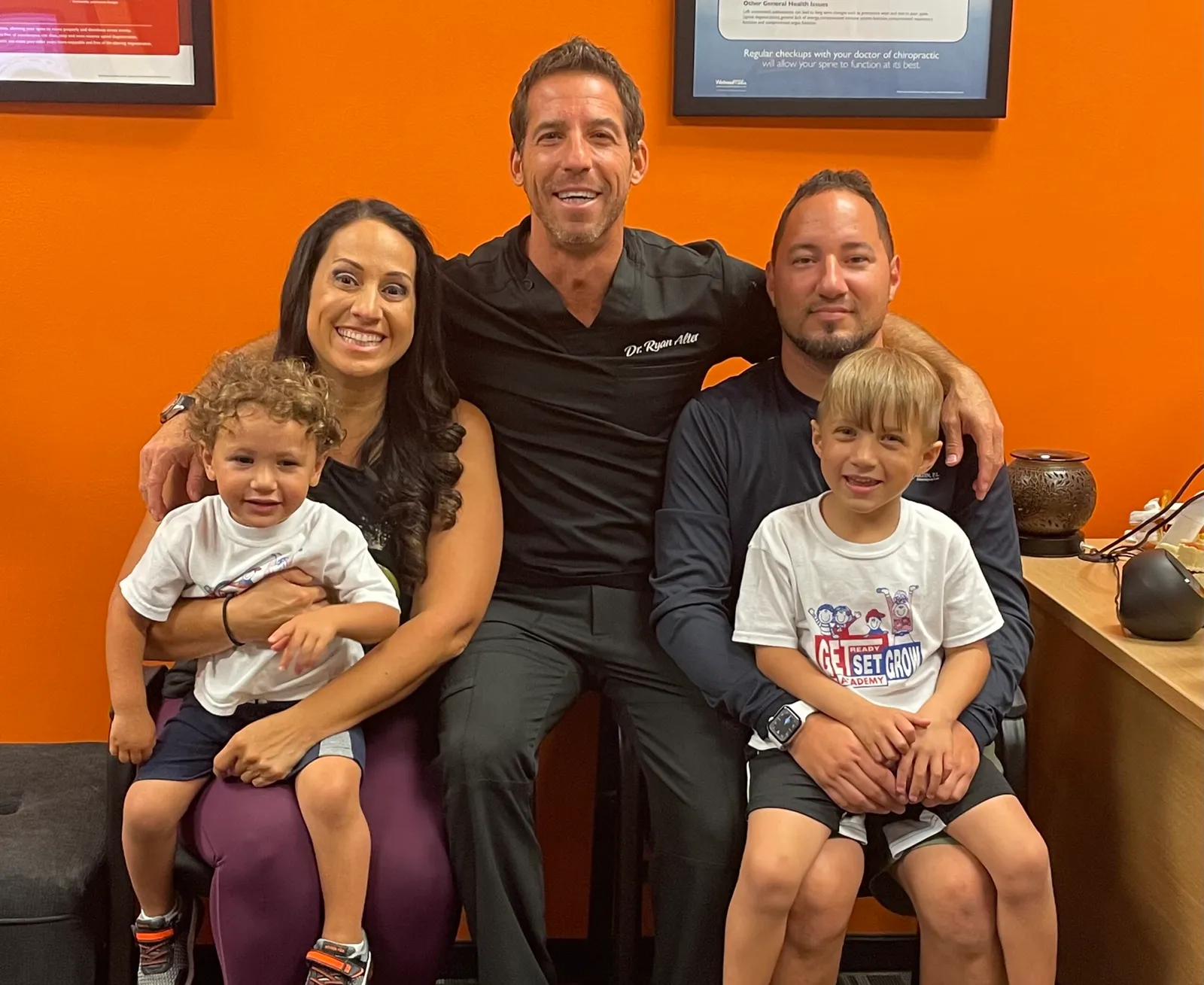Dr. Ryan Alter with a family of four in his office