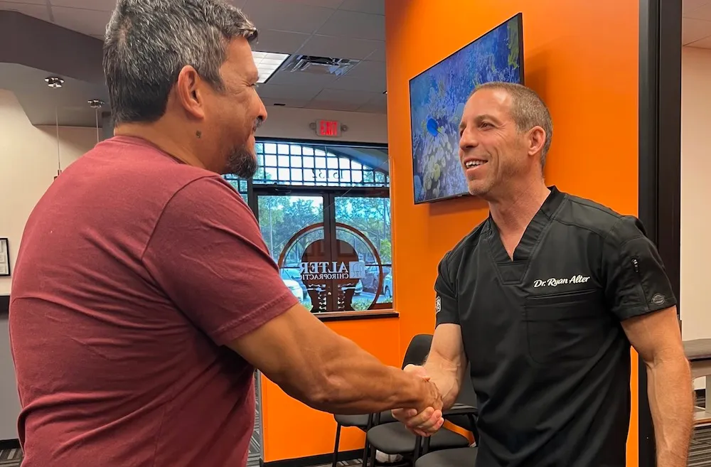 Dr. Alter shaking hands with a patient