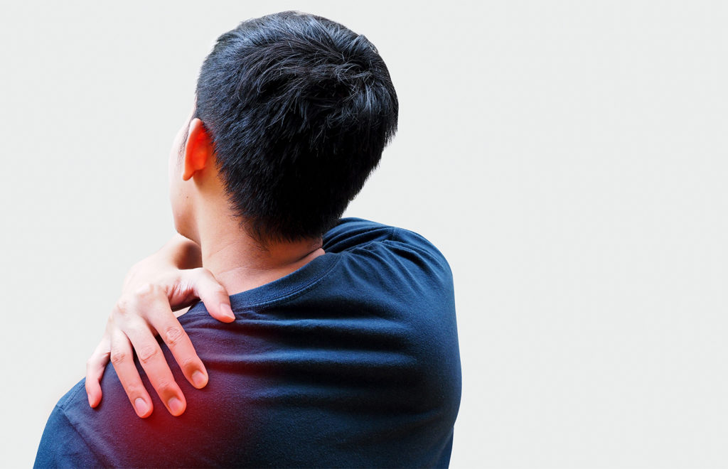 man wearing blue shirt holding his frozen shoulder