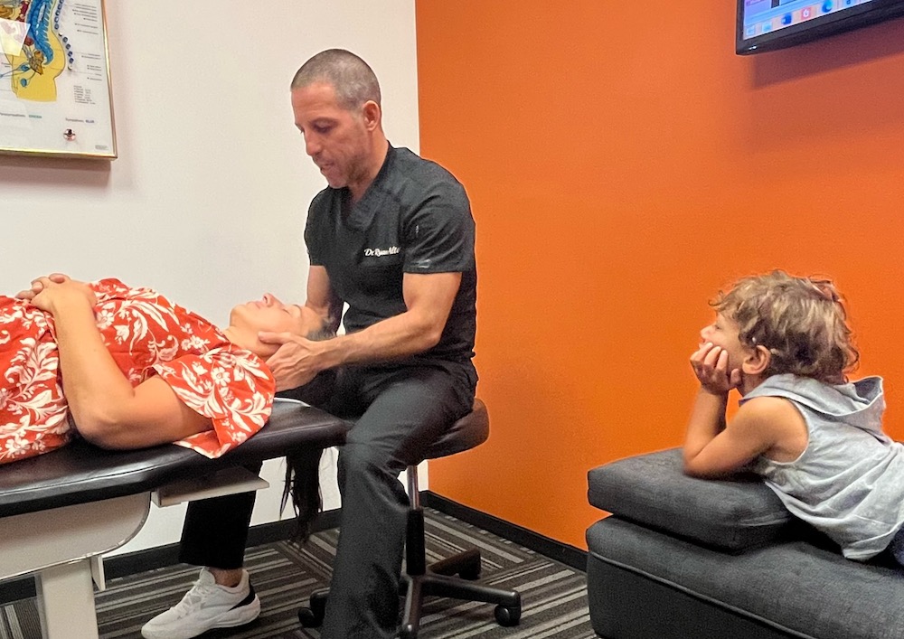 dr ryan alter doing whiplash treatment in patient