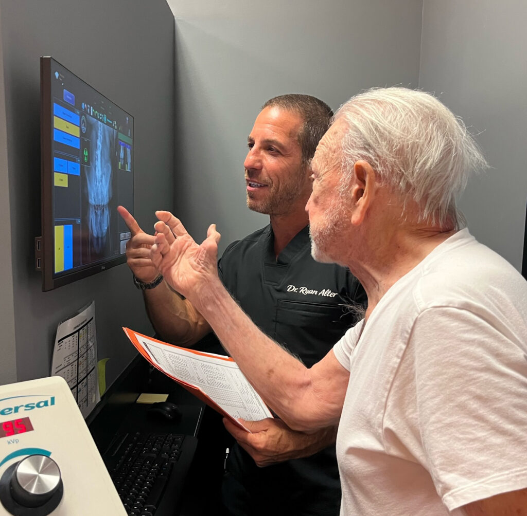 dr ryan alter showing the x-ray result to patient
