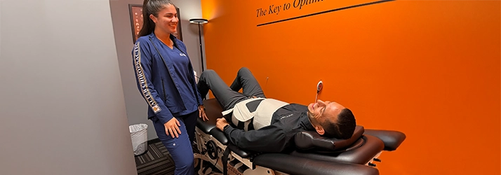 Chiropractic Delray Beach FL Staff Member With Patient On Decompression Machine