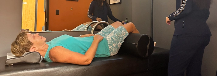 Chiropractic Delray Beach FL Woman On Roller Table Machine