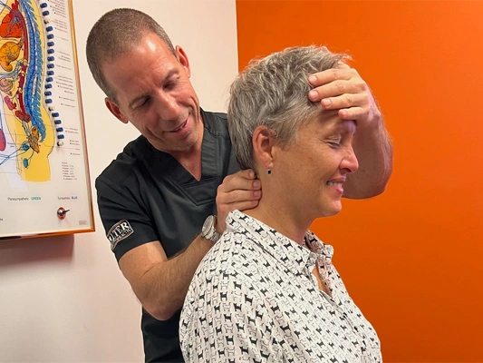 Chiropractor Delray Beach FL Ryan Alter Examining Patient First Visit